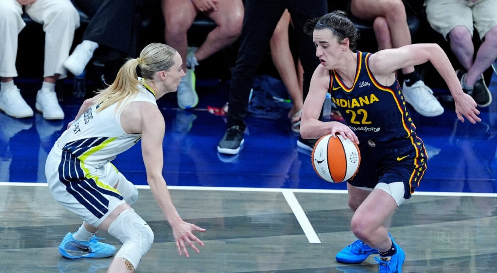WNBA: Indiana Fever guard Caitlin Clark brings the ball up court against Dallas Wings guard Paige Bueckers at Gainbridge Fieldhouse on July 13, 2025