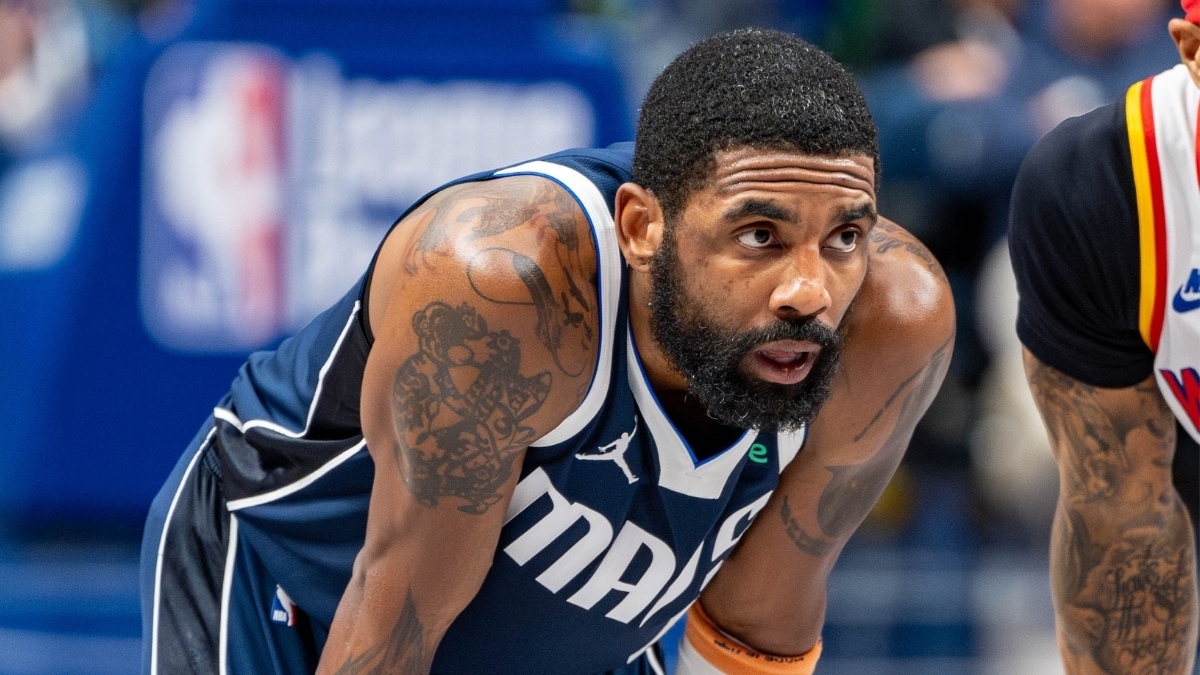 Kyrie Irving leans forward on the court while free throws are attempted during the Dallas Mavericks’ game against the Golden State Warriors at American Airlines Center NBA