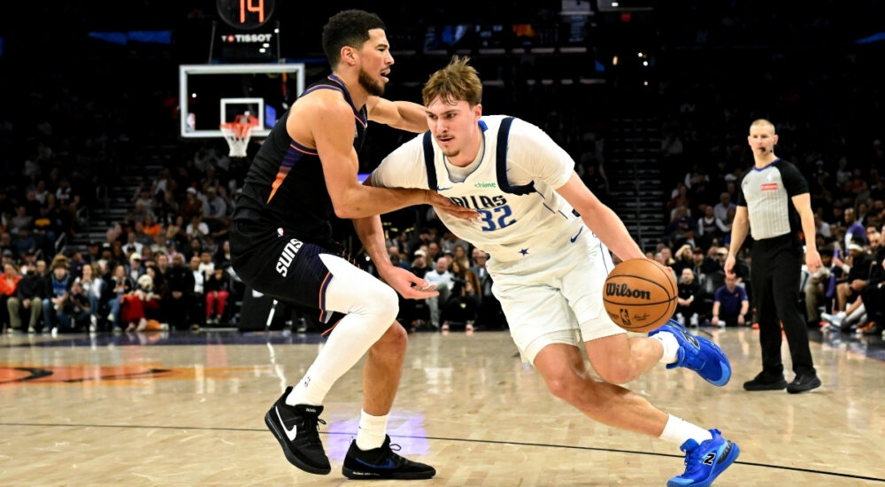NBA: Cooper Flagg dribbles past Devin Booker during the first half of Mavericks vs. Suns at Mortgage Matchup Center in Phoenix.