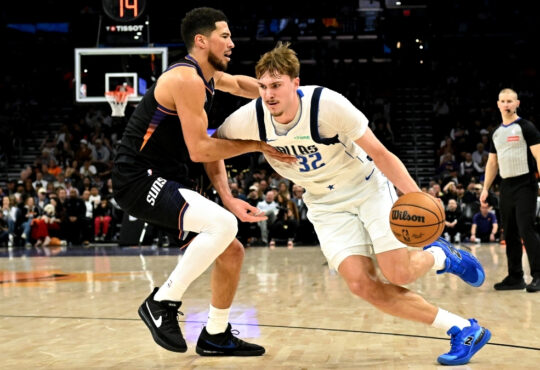 NBA: Cooper Flagg dribbles past Devin Booker during the first half of Mavericks vs. Suns at Mortgage Matchup Center in Phoenix.