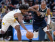 NBA: Khris Middleton of the Dallas Mavericks and Jarace Walker of the Indiana Pacers chase a loose ball during the first half at Gainbridge Fieldhouse against the Indiana Pacers.