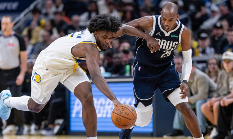 NBA: Khris Middleton of the Dallas Mavericks and Jarace Walker of the Indiana Pacers chase a loose ball during the first half at Gainbridge Fieldhouse against the Indiana Pacers.