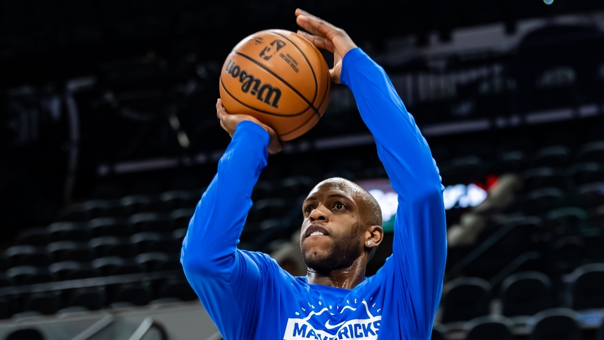 NBA: Khris Middleton takes a jump shot during pregame warmups for the Dallas Mavericks in San Antonio