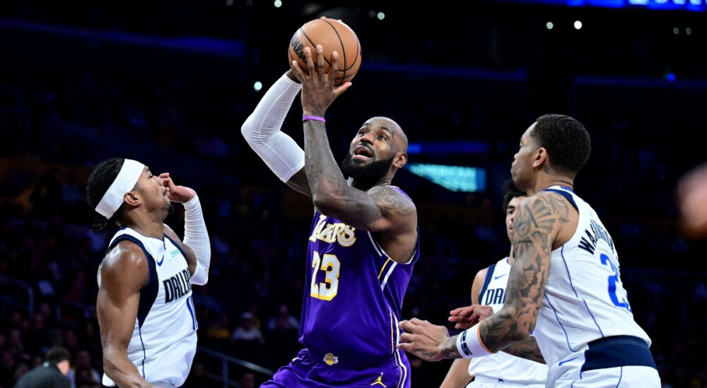NBA: LeBron James drives to the basket at Crypto.com Arena between Brandon Williams and P.J. Washington during Dallas Mavericks vs. Los Angeles Lakers.