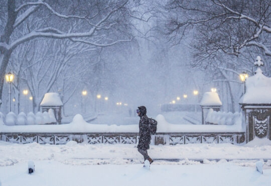 A commuter walks through heavy snowfall in Central Park during a Nor’Easter in New York City.