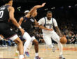 NBA: Naji Marshall brings the ball up court for the Dallas Mavericks while defended by Oso Ighodaro of the Phoenix Suns at Mortgage Matchup Center.