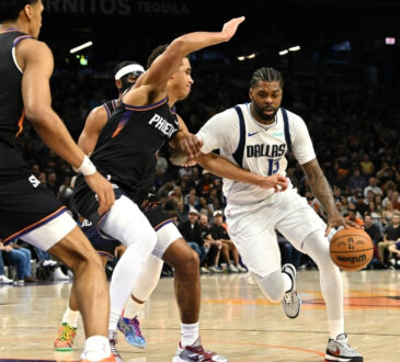 NBA: Naji Marshall brings the ball up court for the Dallas Mavericks while defended by Oso Ighodaro of the Phoenix Suns at Mortgage Matchup Center.