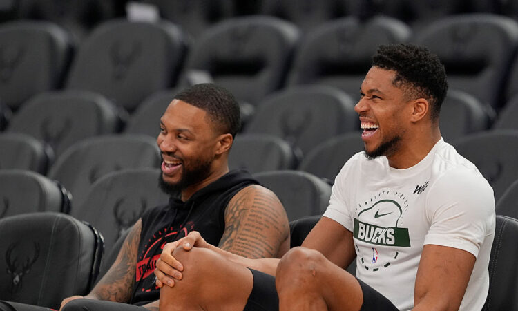 Portland Trail Blazers guard Damian Lillard talks to Milwaukee Bucks forward Giannis Antetokounmpo