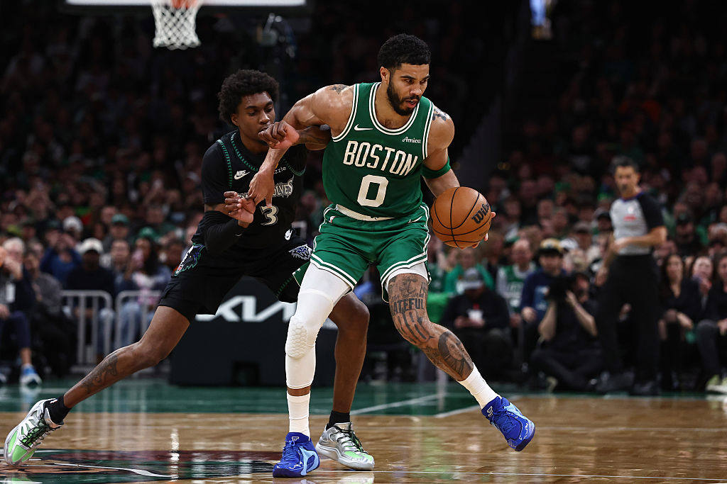 Minnesota Timberwolves forward Jaden McDaniels guards Boston Celtics forward Jayson Tatum