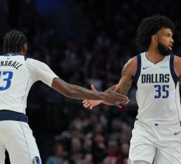 Marvin Bagley III (#35) and Naji Marshall (#13) of the Dallas Mavericks celebrate during a road game against the Portland Trail Blazers at Moda Center on March 27, 2026.