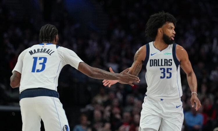 Marvin Bagley III (#35) and Naji Marshall (#13) of the Dallas Mavericks celebrate during a road game against the Portland Trail Blazers at Moda Center on March 27, 2026.