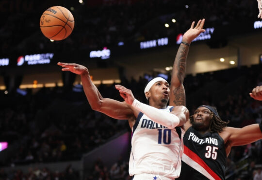 Brandon Williams of the Dallas Mavericks passes away from Robert Williams III of the Portland Trail Blazers during the fourth quarter at Moda Center on December 29, 2025.