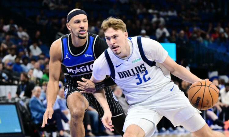 Cooper Flagg #32 of the Dallas Mavericks drives to the basket against Jalen Suggs #4 of the Orlando Magic at Kia Center on March 5, 2026 in Orlando, Florida.