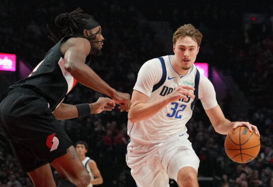 Cooper Flagg #32 of the Dallas Mavericks dribbles against Jerami Grant #9 of the Portland Trail Blazers during a 20-point first half at Moda Center.