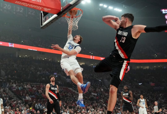Cooper Flagg of the Dallas Mavericks dunks over Donovan Clingan of the Portland Trail Blazers during the first half at Moda Center on March 27, 2026.