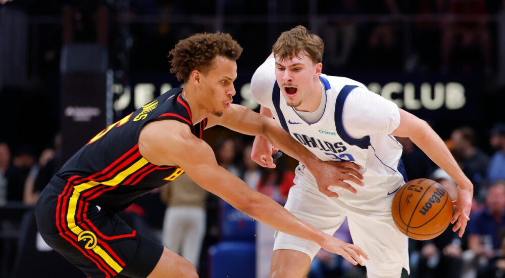 Cooper Flagg #32 of the Dallas Mavericks battles Dyson Daniels #5 of the Atlanta Hawks during the first quarter at State Farm Arena.