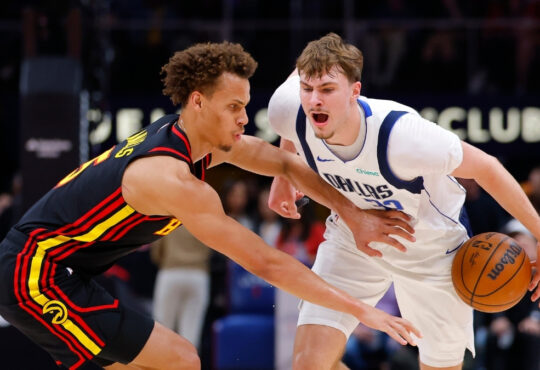 Cooper Flagg #32 of the Dallas Mavericks battles Dyson Daniels #5 of the Atlanta Hawks during the first quarter at State Farm Arena.