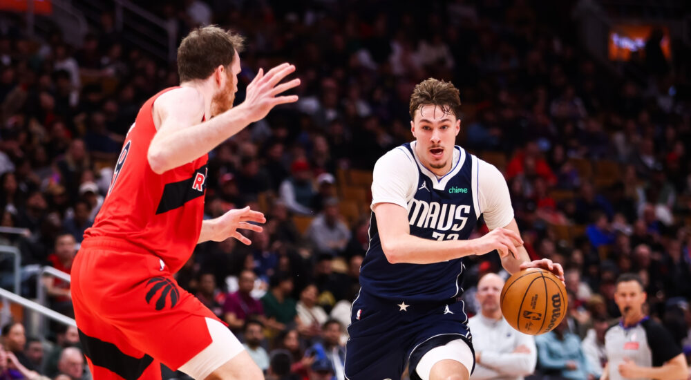 Cooper Flagg #32 of the Dallas Mavericks drives to the basket against Jakob Poeltl #19 of the Toronto Raptors at Scotiabank Arena on March 8, 2026.