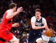 Cooper Flagg #32 of the Dallas Mavericks drives to the basket against Jakob Poeltl #19 of the Toronto Raptors at Scotiabank Arena on March 8, 2026.