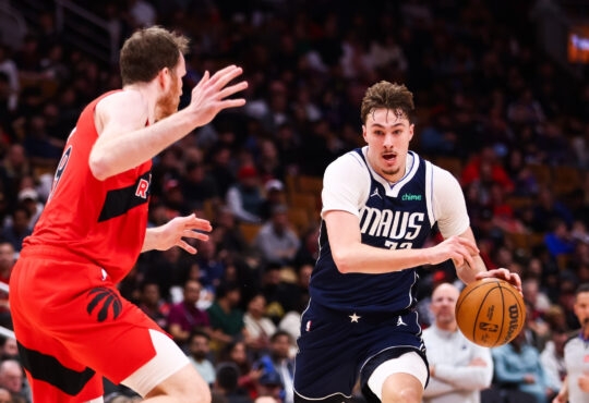Cooper Flagg #32 of the Dallas Mavericks drives to the basket against Jakob Poeltl #19 of the Toronto Raptors at Scotiabank Arena on March 8, 2026.