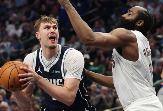 Cooper Flagg #32 of the Dallas Mavericks is defended by James Harden #1 of the Cleveland Cavaliers during the first half at American Airlines Center on March 13, 2026 in Dallas, Texas.