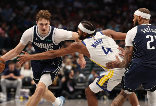 Dallas Mavericks rookie Cooper Flagg drives against Moses Moody of the Golden State Warriors during the third quarter at American Airlines Center on March 23, 2026.