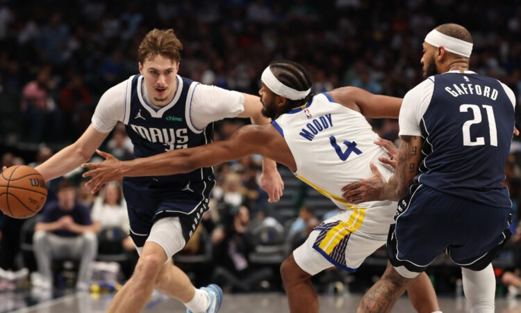 Dallas Mavericks rookie Cooper Flagg drives against Moses Moody of the Golden State Warriors during the third quarter at American Airlines Center on March 23, 2026.