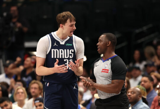 Cooper Flagg talks to referee Dedric Taylor during the Mavericks’ game against the Warriors at American Airlines Center.
