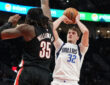 Cooper Flagg of the Dallas Mavericks shoots over Robert Williams III of the Portland Trail Blazers during the first half at Moda Center on March 27, 2026.