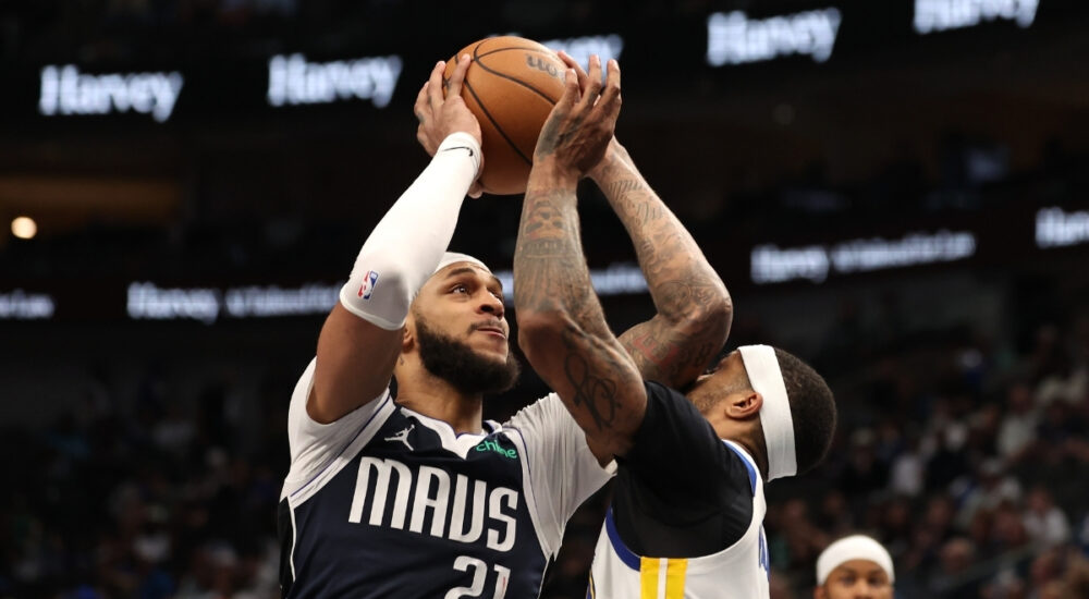 Daniel Gafford of the Dallas Mavericks is defended by Gary Payton II of the Golden State Warriors during the fourth quarter on March 23, 2026 in Dallas.