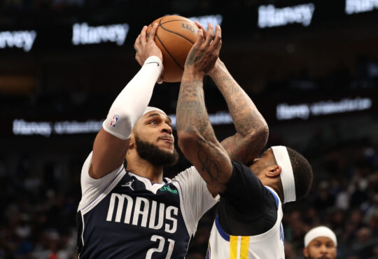 Daniel Gafford of the Dallas Mavericks is defended by Gary Payton II of the Golden State Warriors during the fourth quarter on March 23, 2026 in Dallas.