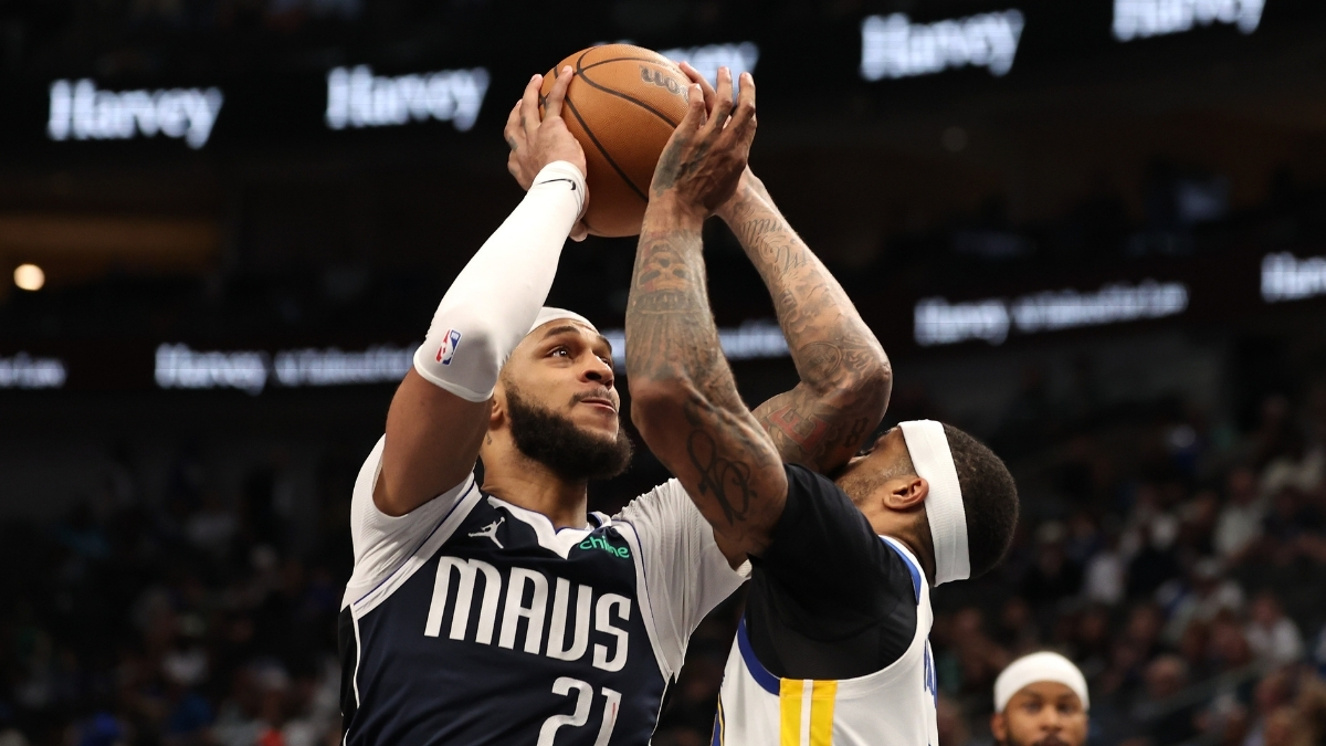 Daniel Gafford of the Dallas Mavericks is defended by Gary Payton II of the Golden State Warriors during the fourth quarter on March 23, 2026 in Dallas.