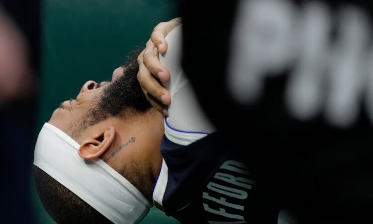 Daniel Gafford of the Dallas Mavericks reacts to a right shoulder injury during the second quarter against the Milwaukee Bucks at Fiserv Forum.