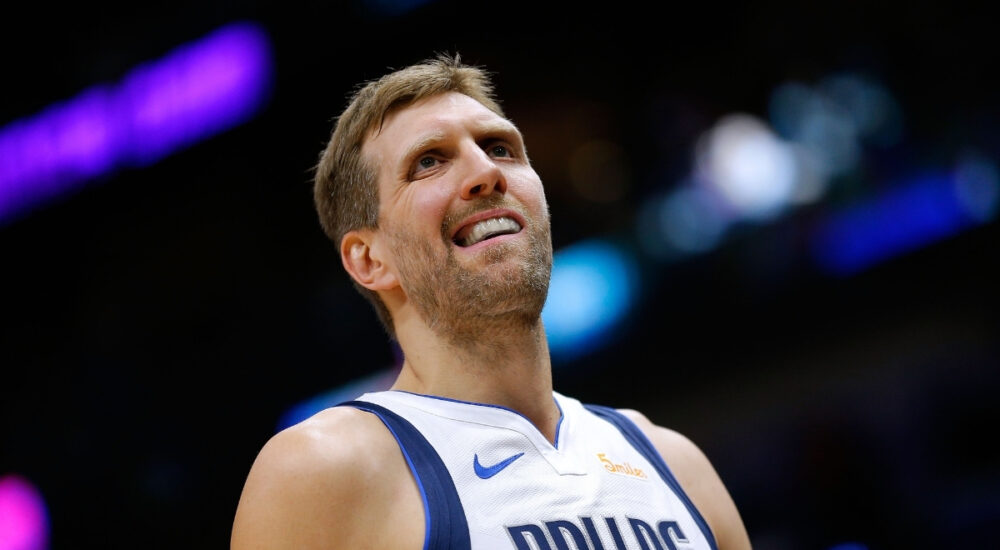 Dirk Nowitzki of the Dallas Mavericks wearing a blue away jersey and reacting during a game against the New Orleans Pelicans at Smoothie King Center.