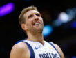 Dirk Nowitzki of the Dallas Mavericks wearing a blue away jersey and reacting during a game against the New Orleans Pelicans at Smoothie King Center.
