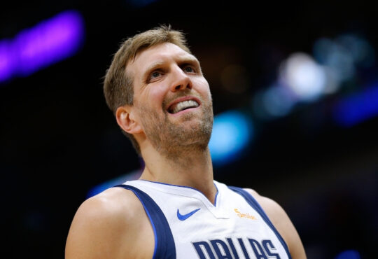Dirk Nowitzki of the Dallas Mavericks wearing a blue away jersey and reacting during a game against the New Orleans Pelicans at Smoothie King Center.