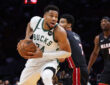 Giannis Antetokounmpo of the Milwaukee Bucks drives to the basket against the Miami Heat defense at Kaseya Center.
