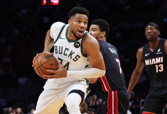 Giannis Antetokounmpo of the Milwaukee Bucks drives to the basket against the Miami Heat defense at Kaseya Center.
