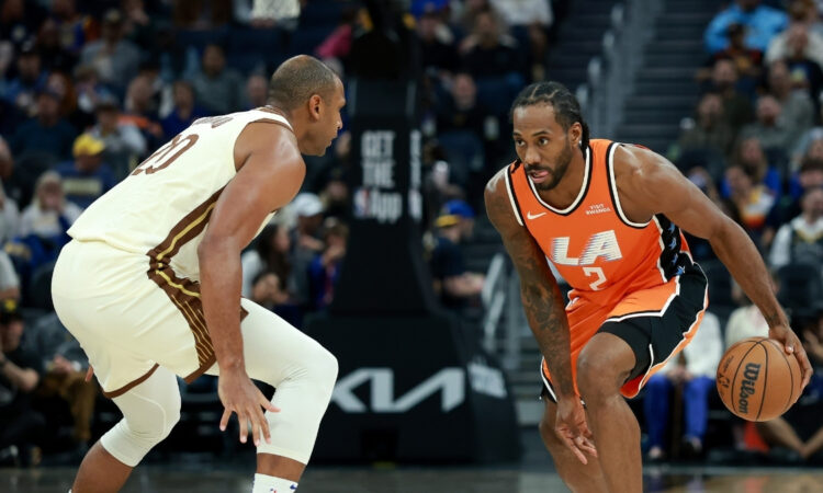 Kawhi Leonard of the LA Clippers drives toward the basket while being guarded by Al Horford of the Golden State Warriors at Chase Center.