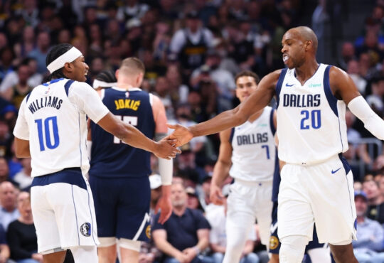 Khris Middleton and Brandon Williams of the Dallas Mavericks react after a play against the Denver Nuggets during the third quarter at Ball Arena on March 25, 2026.