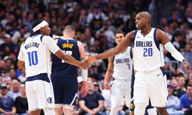 Khris Middleton and Brandon Williams of the Dallas Mavericks react after a play against the Denver Nuggets during the third quarter at Ball Arena on March 25, 2026.
