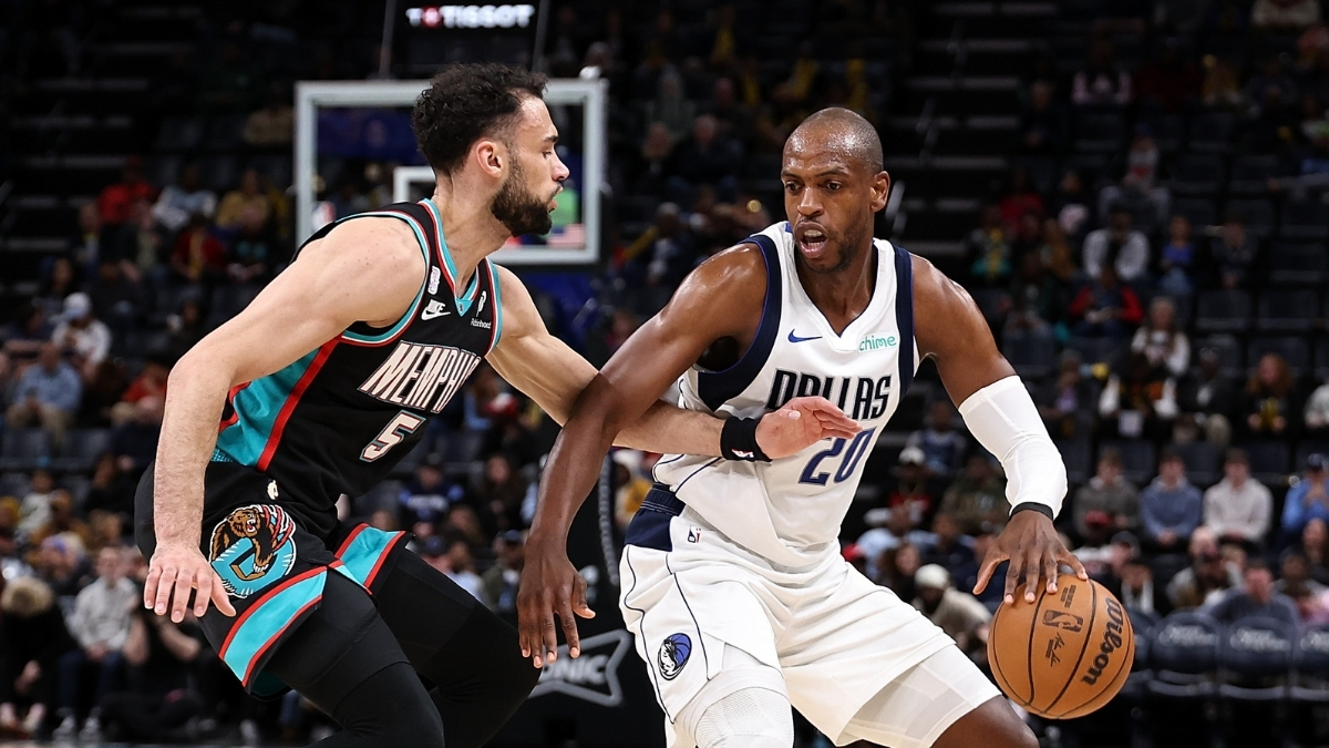 Khris Middleton of the Dallas Mavericks handles the ball against Tyler Burton of the Memphis Grizzlies during the first half at FedExForum on March 12, 2026.
