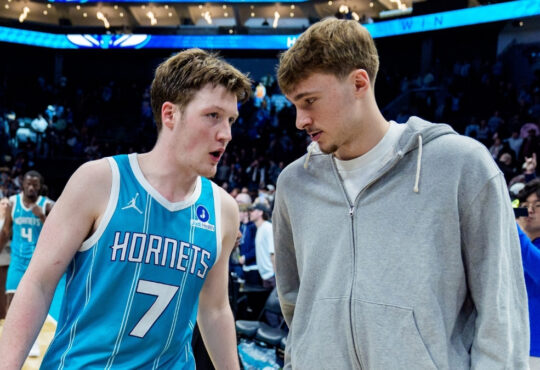 Kon Knueppel of the Charlotte Hornets talks with Cooper Flagg of the Dallas Mavericks after their March 3, 2026 game at Spectrum Center in Charlotte, North Carolina.