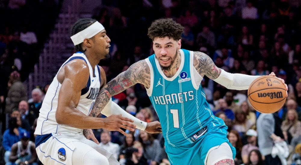 NBA: LaMelo Ball brings the ball up court for the Charlotte Hornets while guarded by Brandon Williams of the Dallas Mavericks during a game at Spectrum Center.