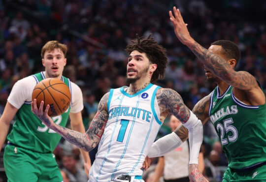 NBA: LaMelo Ball drives to the basket past P.J. Washington during the second quarter at American Airlines Center against the Dallas Mavericks.