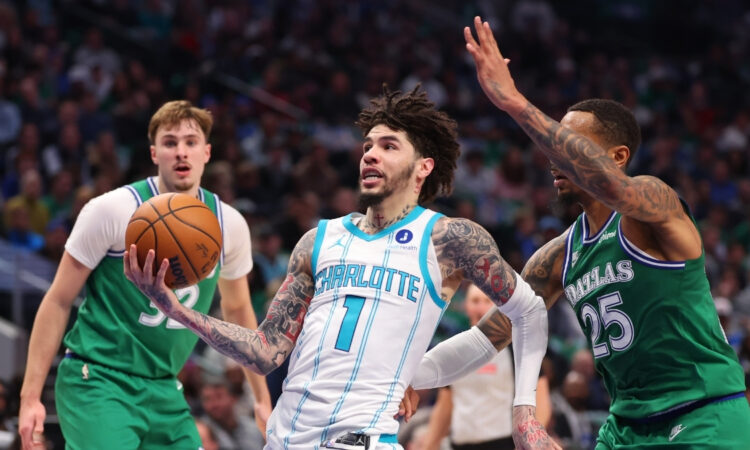 NBA: LaMelo Ball drives to the basket past P.J. Washington during the second quarter at American Airlines Center against the Dallas Mavericks.