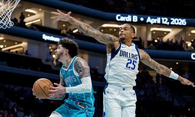 NBA: LaMelo Ball drives to the basket for the Charlotte Hornets while guarded by P.J. Washington of the Dallas Mavericks at Spectrum Center.