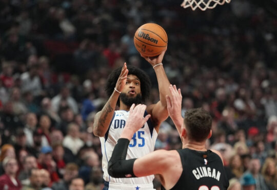 Marvin Bagley III #35 of the Dallas Mavericks shoots a jumper over Donovan Clingan #23 of the Portland Trail Blazers at Moda Center.