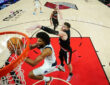 Marvin Bagley III of the Dallas Mavericks attempts a layup defended by Donovan Clingan of the Portland Trail Blazers during the second half at Moda Center on March 27, 2026.