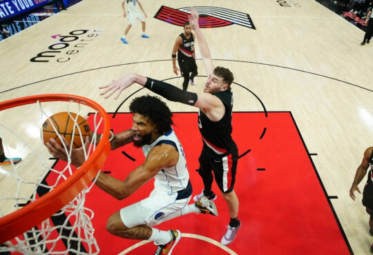 Marvin Bagley III of the Dallas Mavericks attempts a layup defended by Donovan Clingan of the Portland Trail Blazers during the second half at Moda Center on March 27, 2026.